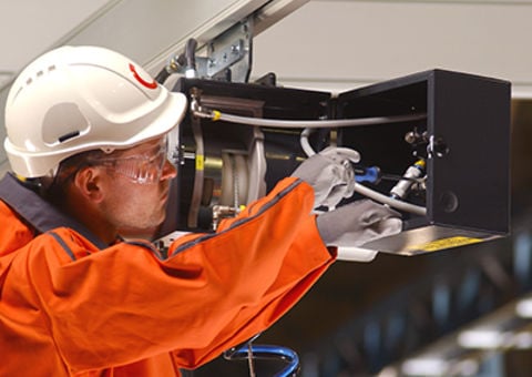 Technician working on chain hoist