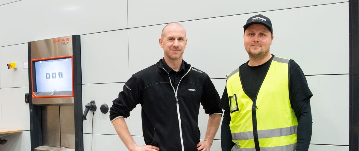 Valmet employees in front of Agilon automated warehouse, improving operational efficiency and smooth operations with Konecranes Agilon warehouse automation.