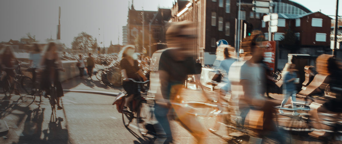 People cycling in a summery city