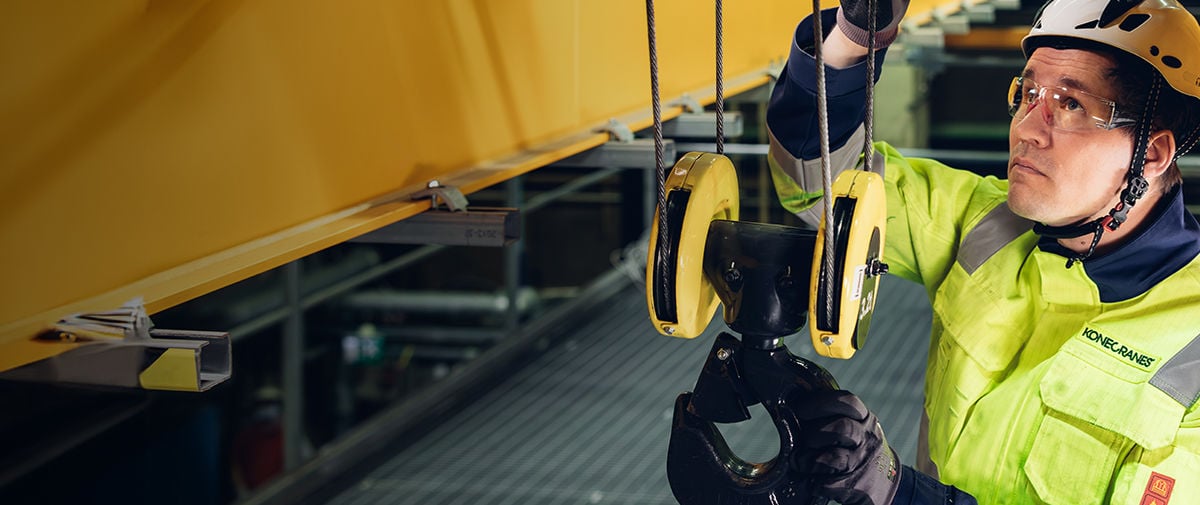 Service technician inspecting overhead crane